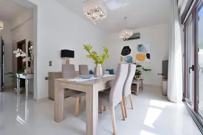 a dining room with a wooden table and chairs at Chania Boutique Villa - steps from the beach in Chania Town