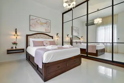 a bedroom with a large bed and a mirror at Chania Boutique Villa - steps from the beach in Chania Town
