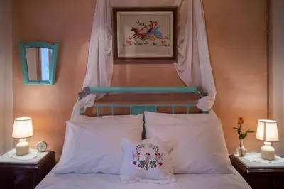 a bed with a headboard with white pillows at villa archontiko ASKYFOU SFAKIA in Karés