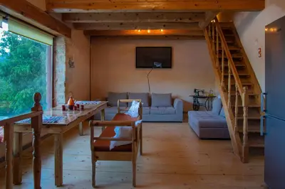 a living room with a table and a couch at villa archontiko ASKYFOU SFAKIA in Karés