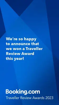 a blue sign that says were so happy to announce that we won a traveler at Xenia's countryside guesthouse in Agia Marina Nea Kydonias
