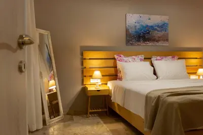 a bedroom with a large bed and a mirror at koukounari apartment in Chania city center in Chania Town
