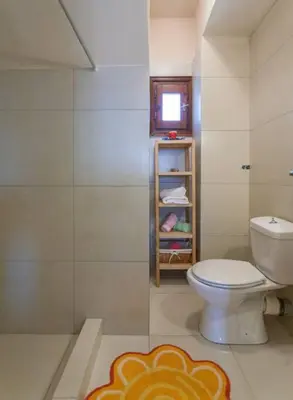 a bathroom with a toilet and a glass shower at Villa Seashell, Private Pool and Magnficent View in Ravdhoúkha