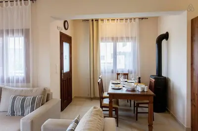 a living room with a table and a couch at Villa Seashell, Private Pool and Magnficent View in Ravdhoúkha