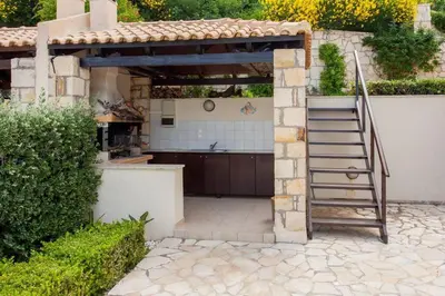 a kitchen with a stairway leading into a yard at Villa Seashell, Private Pool and Magnficent View in Ravdhoúkha