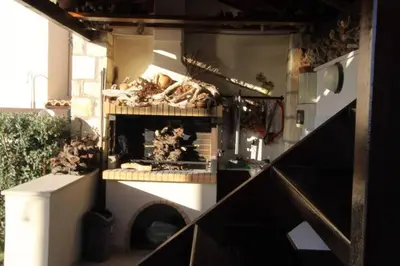 a kitchen with a brick oven with food on shelves at Villa Seashell, Private Pool and Magnficent View in Ravdhoúkha