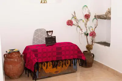 a room with a table with a red blanket on it at Casa Elafonisi N1- 10min from the beach in Plokamianá