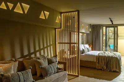 a bedroom with a bed and a couch and a mirror at Casbah Boutique Hotel in Palaiochóra