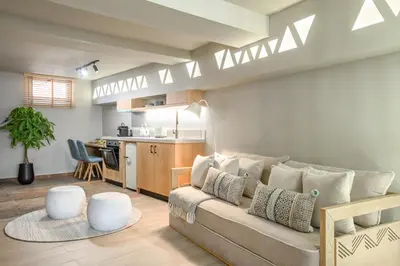 a living room with a couch and a kitchen at Casbah Boutique Hotel in Palaiochóra