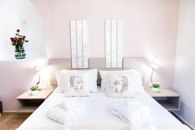 a bedroom with a bed with two towels on it at Sonio Villas - Que Bella Collection in Plataniás