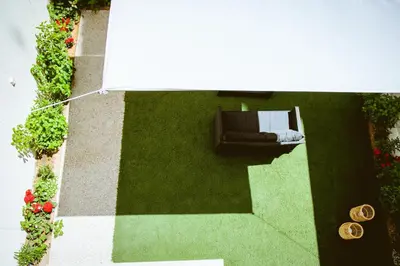 an overhead view of a patio with a couch and flowers at Emeli Suites in Chania Town