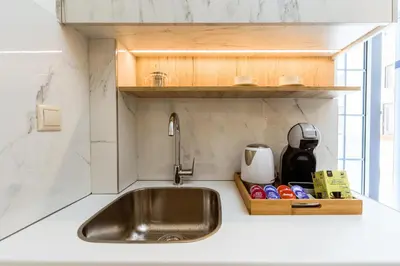a sink in a kitchen with a counter top at Emeli Suites in Chania Town