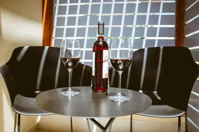 a table with two glasses and a bottle of wine at Emeli Suites in Chania Town