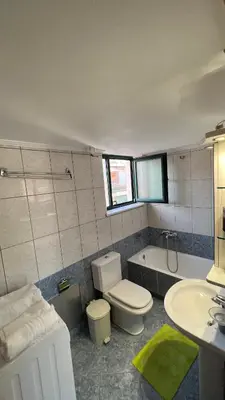 a bathroom with a toilet and a sink and a tub at Eteá Urban Nest living In the Heart of Chania in Chania Town