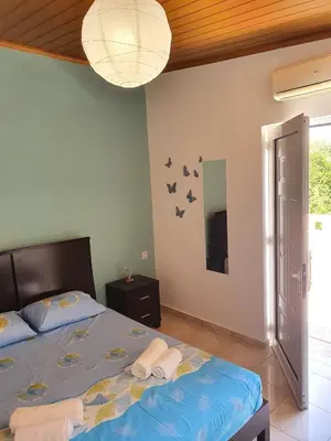a bedroom with a bed with two towels on it at Chania Casa Portokali in Perivólia
