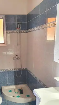 a bathroom with a shower and a bath tub at Chania Casa Portokali in Perivólia