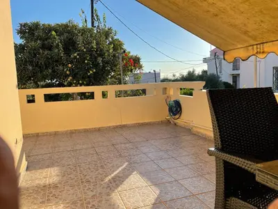 a balcony with a yellow fence and a patio at Chania Casa Portokali in Perivólia