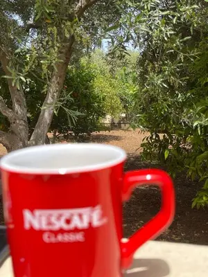 a red coffee cup sitting on a table at Chania Casa Portokali in Perivólia