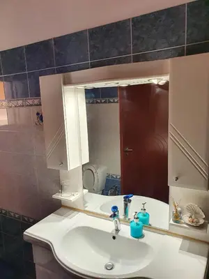 a bathroom with a sink and a mirror at Chania Casa Portokali in Perivólia