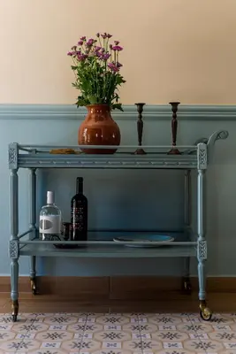 a blue shelf with a vase with flowers on it at Villa Remedio in Néon Khoríon