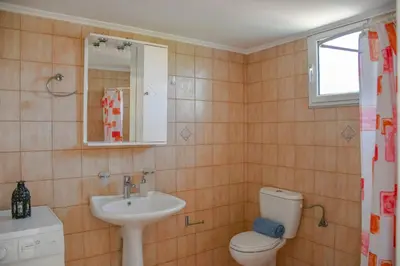 a bathroom with a toilet and a sink at Katerina's house in Kefálion