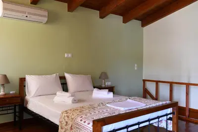 a bedroom with a bed with towels on it at Katerina's house in Kefálion