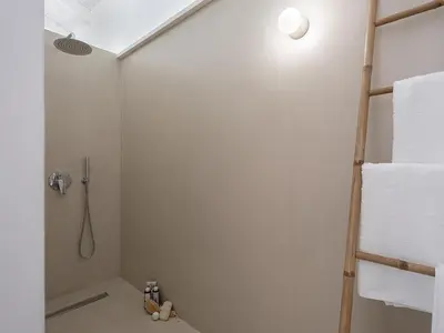 a bathroom with a shower and white towels at Lithos Retreat (ΛΙTHOS Retreat) in Kolymvari