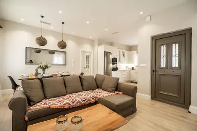 a living room with a couch and a table at Amalthia Casa by 8essentially in Chania Town