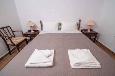 a large bed with white towels on top of it at Vintage project house in Kalyves
