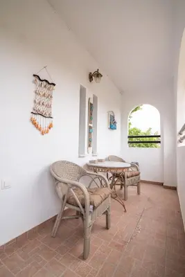 a room with two chairs and a table at Vintage project house in Kalyves