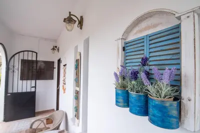 a room with two blue buckets filled with purple flowers at Vintage project house in Kalyves