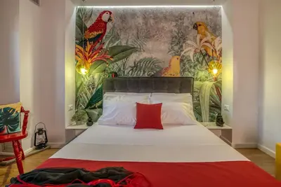 a bedroom with a bed with a painting on the wall at Casa Del Miele, private pool, BBQ, mountain view. in Alikianós