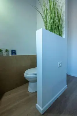 a bathroom with a toilet and a potted plant at Casa Del Miele, private pool, BBQ, mountain view. in Alikianós