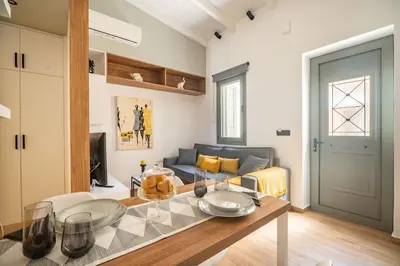 a living room with a table and a couch at Antigone's Lux Home 10mins walk to beach, old town, city in Chania Town