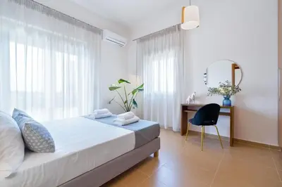 a bedroom with a bed and a desk and a mirror at Villa Anastasia with private heated pool and privacy in Chania Town