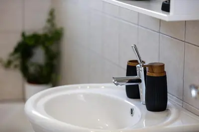 a bathroom sink with a faucet next to a sink at Adelphes Beachfront Apartment with direct connection to the beach in Chania Town