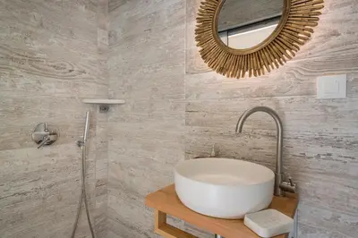 a bathroom with a sink and a mirror at Belle Epoque Halepa's House & Studio in Chania Town
