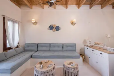 a living room with a blue couch and a table at Belle Epoque Halepa's House in Chania Town