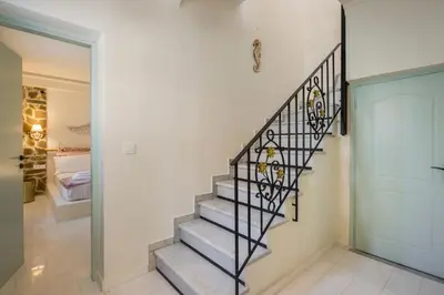 a staircase in a home with a glass door at Belle Epoque Halepa's House in Chania Town