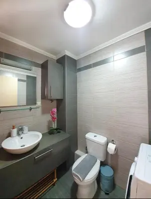 a bathroom with a white toilet and a sink at Callisto in Chania Town