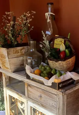 a box of fruit and a basket of vegetables on a table at Origeo casa in Maleme