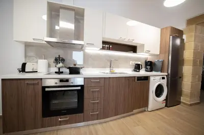 a kitchen with a washer and a sink and a dishwasher at Villa Konstantinos in Azoyirás