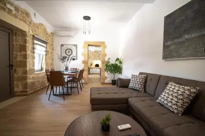 a living room with a couch and a table at Villa Konstantinos in Azoyirás