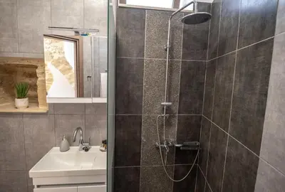 a bathroom with a shower and a sink at Villa Konstantinos in Azoyirás