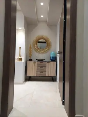 a hallway with a large mirror and a dresser at Rika’s seaside apartments in Chania Town