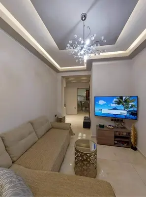 a living room with a couch and a flat screen tv at Rika’s seaside apartments in Chania Town