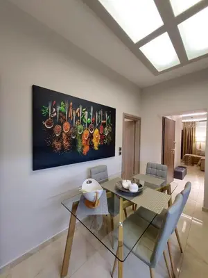 a dining room with a table and a painting on the wall at Rika’s seaside apartments in Chania Town