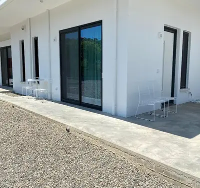 a group of chairs sitting outside of a building at Lefko Apartments in Tavronitis