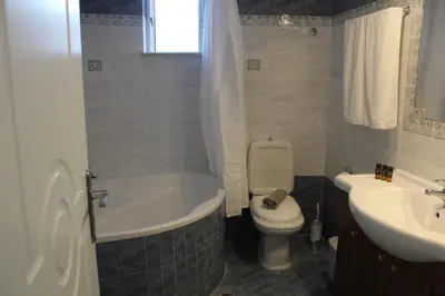 a bathroom with a tub and a toilet and a sink at Kissamos Nice Apartment2 in Kissamos