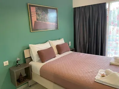 a bedroom with a large bed and a window at Kissamos Nice Apartment2 in Kissamos